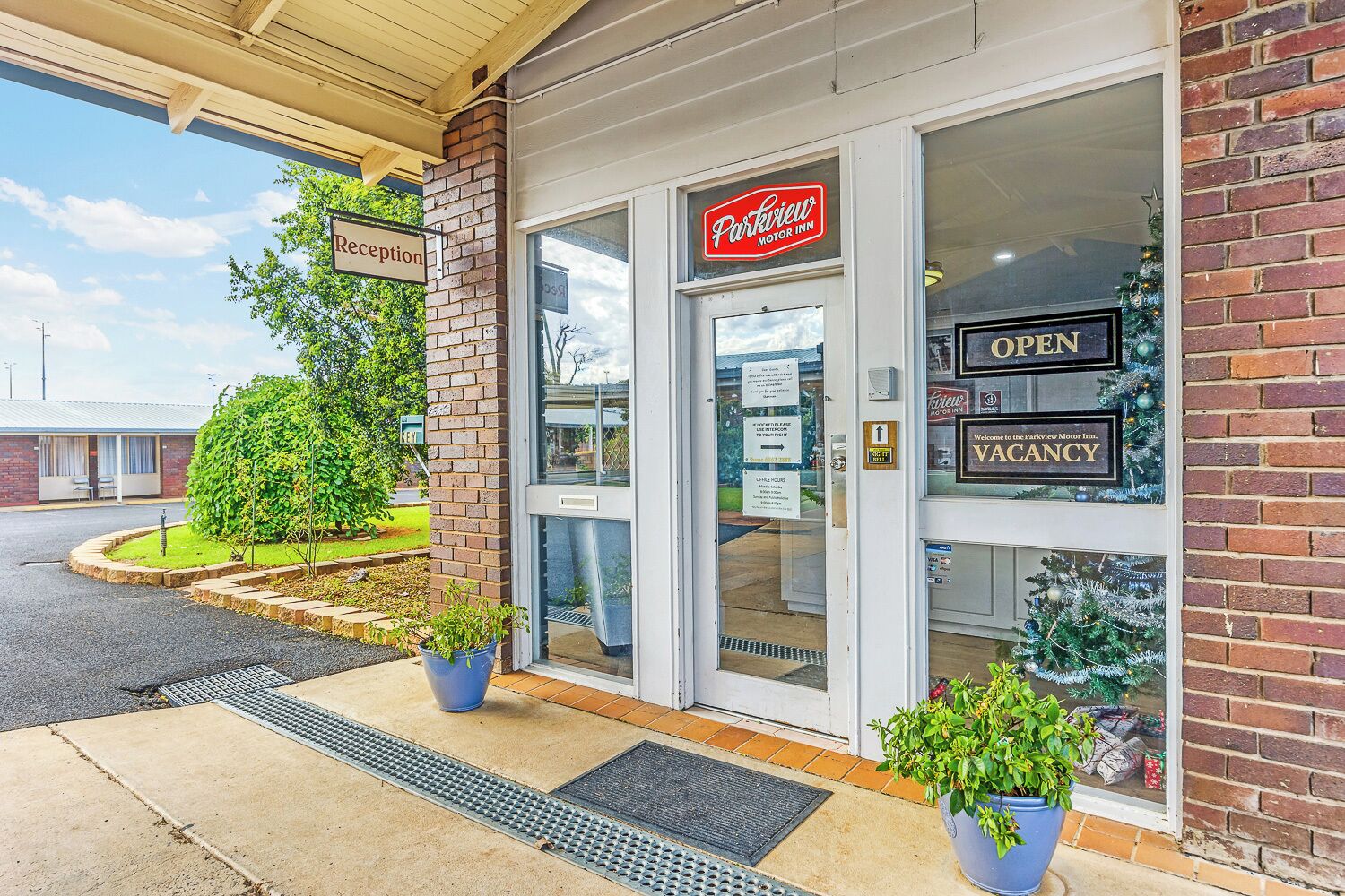 A reception area with a sign for "Parkview Motor Inn" and a "Reception" sign.