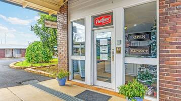 A reception area with a sign for "Parkview Motor Inn" and a "Reception" sign.