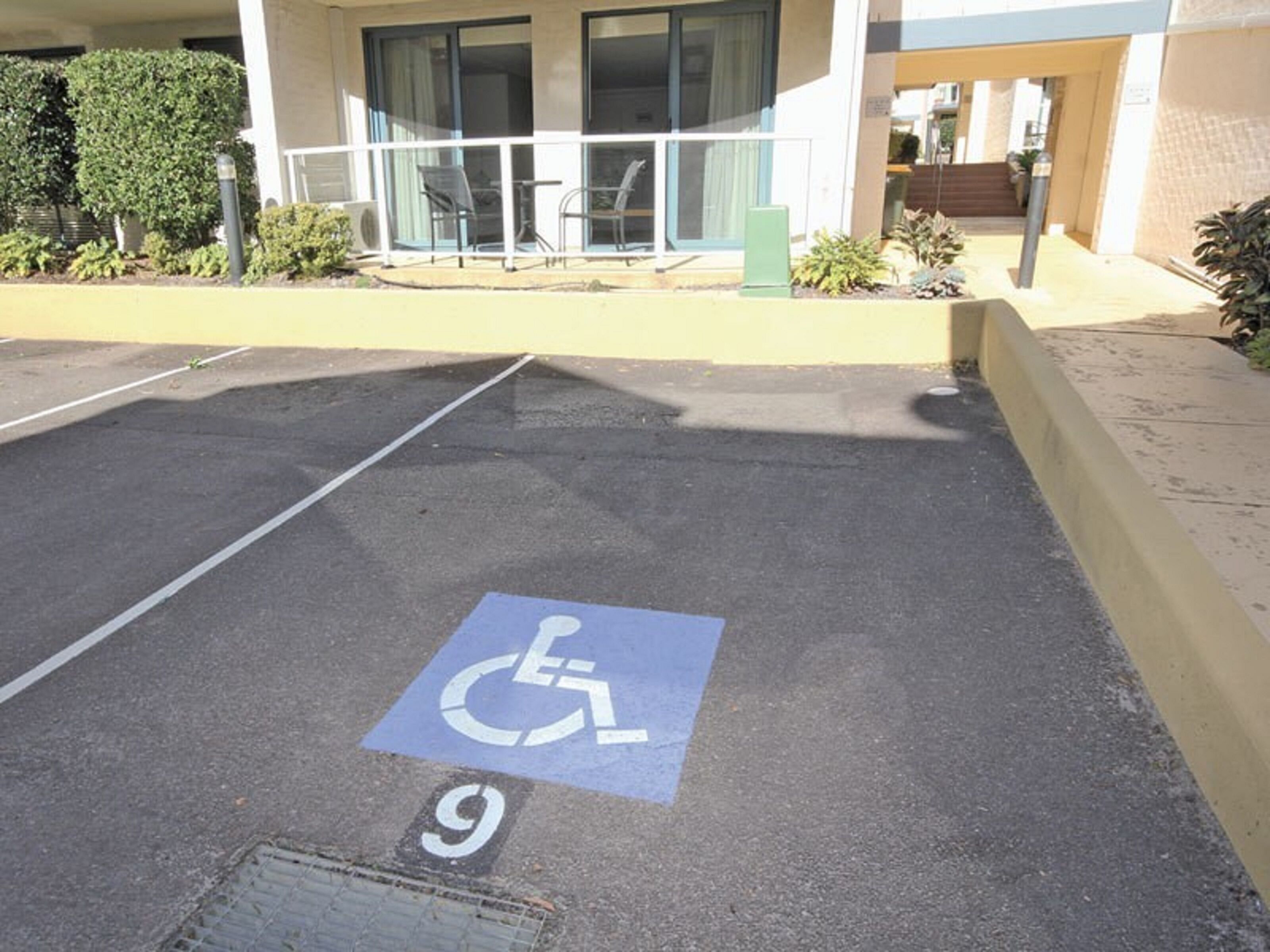 A parking space marked with a wheelchair accessibility symbol and the number 9.
