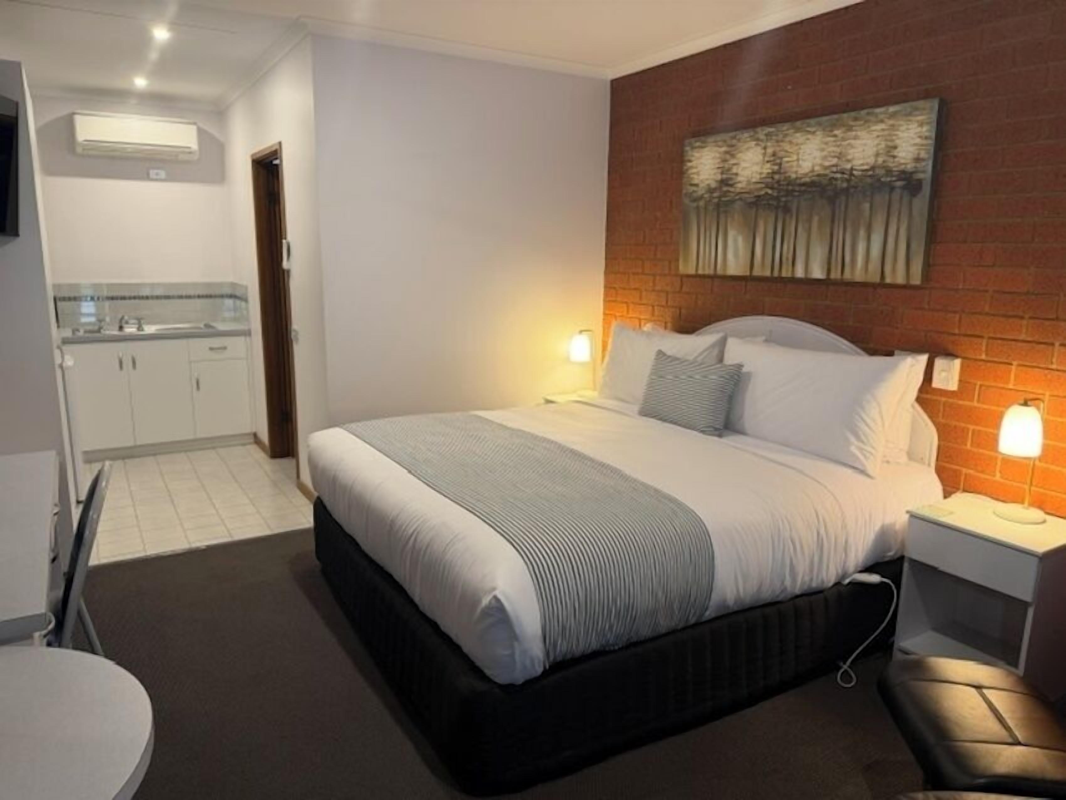 Budget King Room | Premium bedding, down comforters, pillowtop beds, blackout drapes
