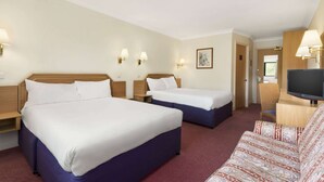A hotel room with two beds, a TV, and a sofa. - Days Inn by Wyndham Watford Gap (Northampton)