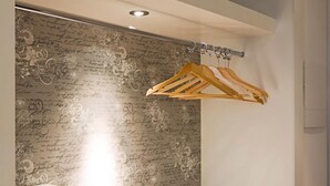 A modern bathroom with a vanity, a towel rack, and a decorative wall.