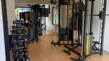 A gym with various exercise equipment, including dumbbells and weight machines.