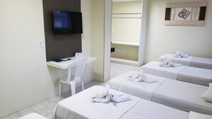 A hotel room with two beds, a desk, a chair, a TV, and a mirror. - Guarany Hotel Express (João Pessoa)