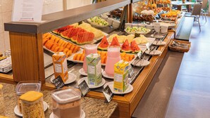 A buffet with various food items and beverages.