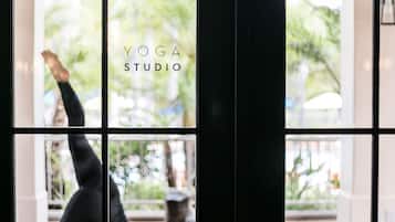 A yoga studio with a large window and a black door.