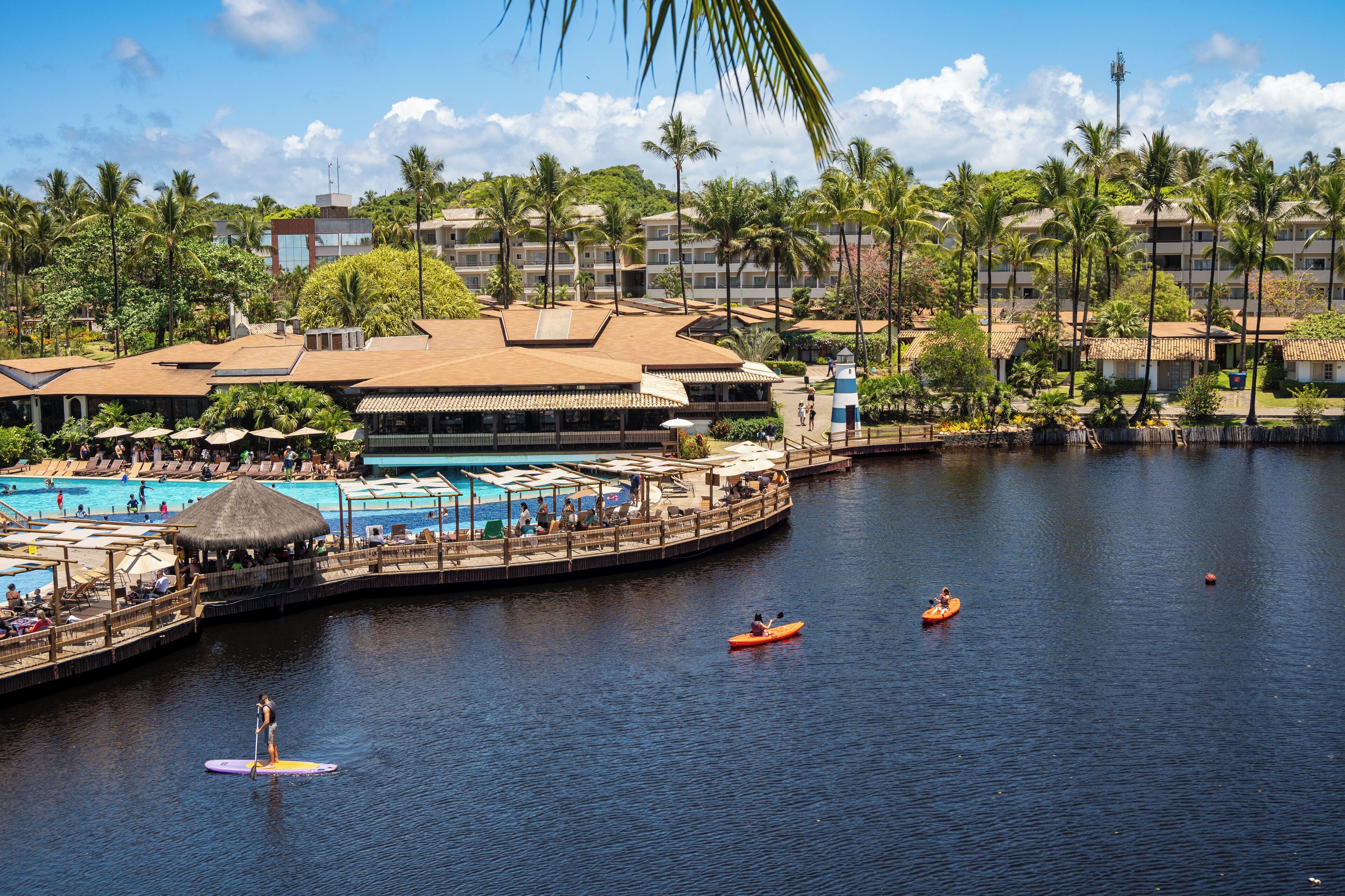 A resort with a pool, a dock, and a waterway.