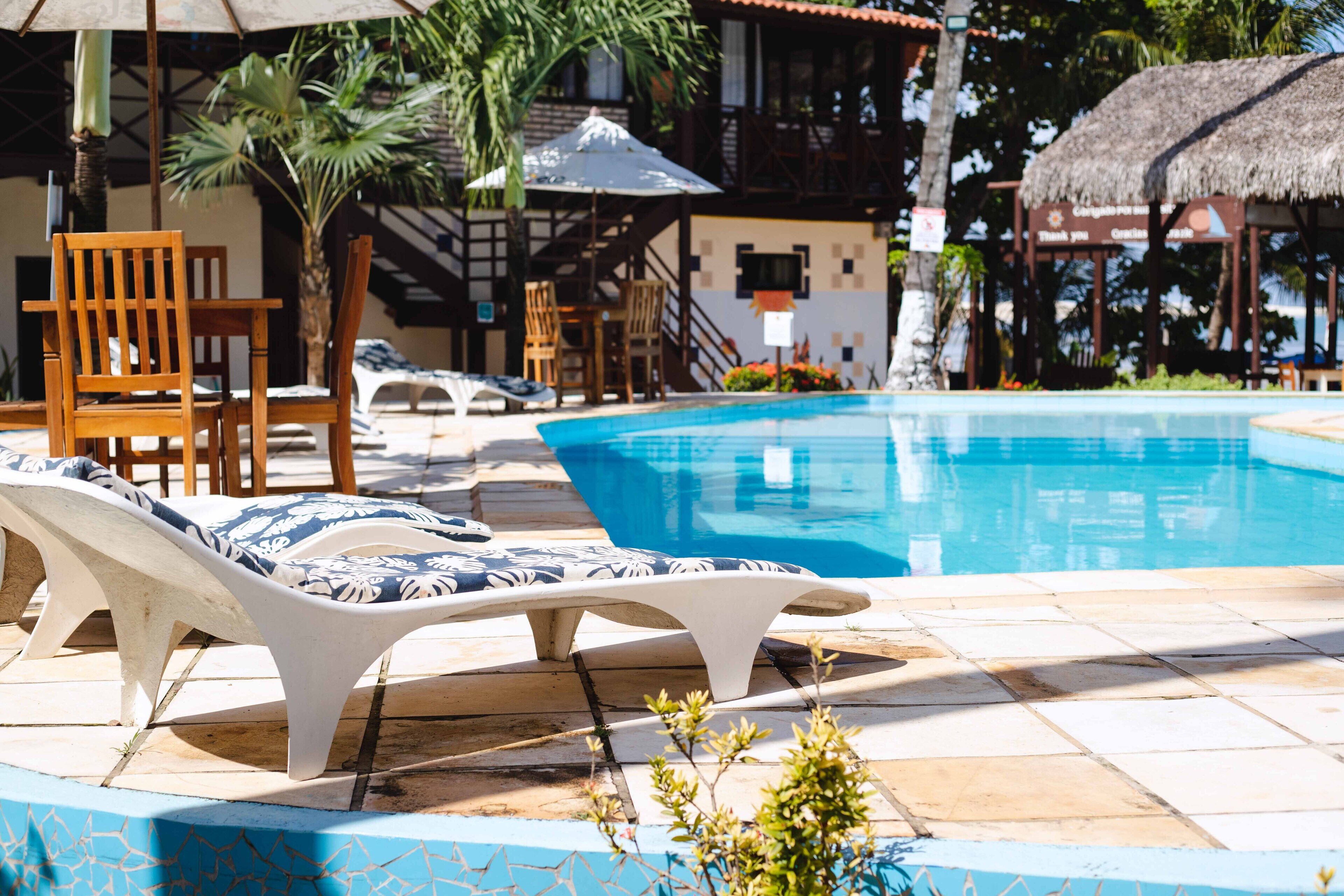 outdoor pool, open 9:00 am to 8:00 pm, pool umbrellas, pool loungers