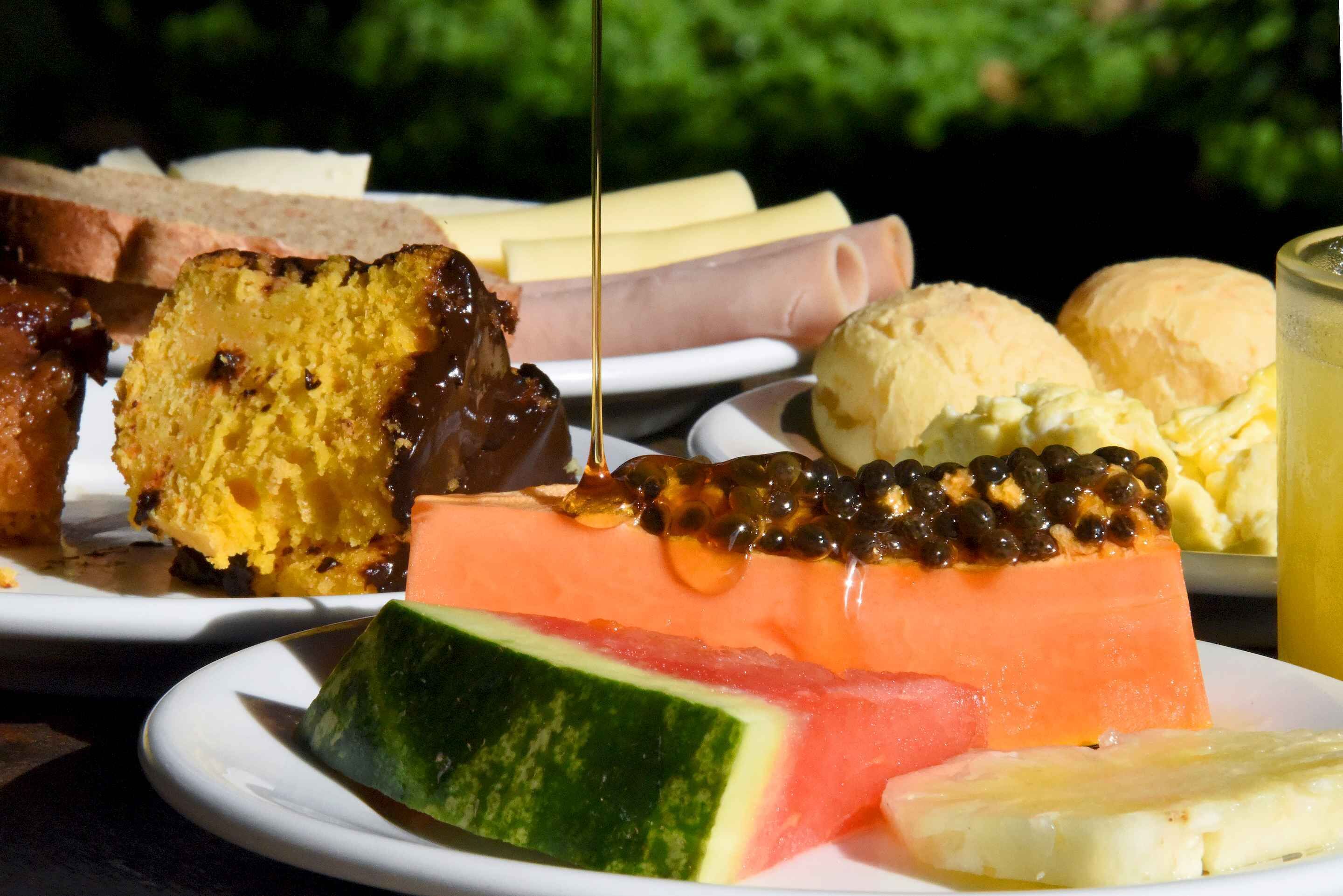 A variety of food items including bread, cheese, ham, watermelon, and ice cream.