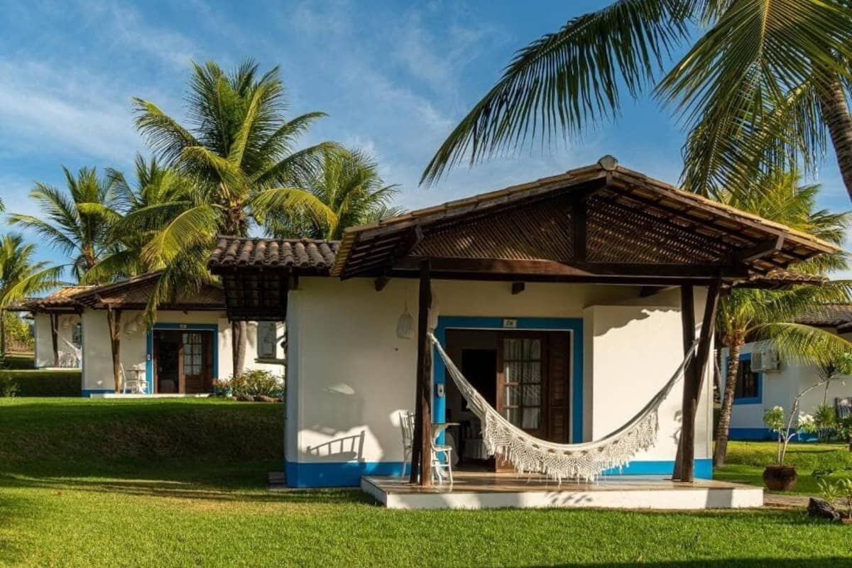 A two-story building with a porch and a hammock.