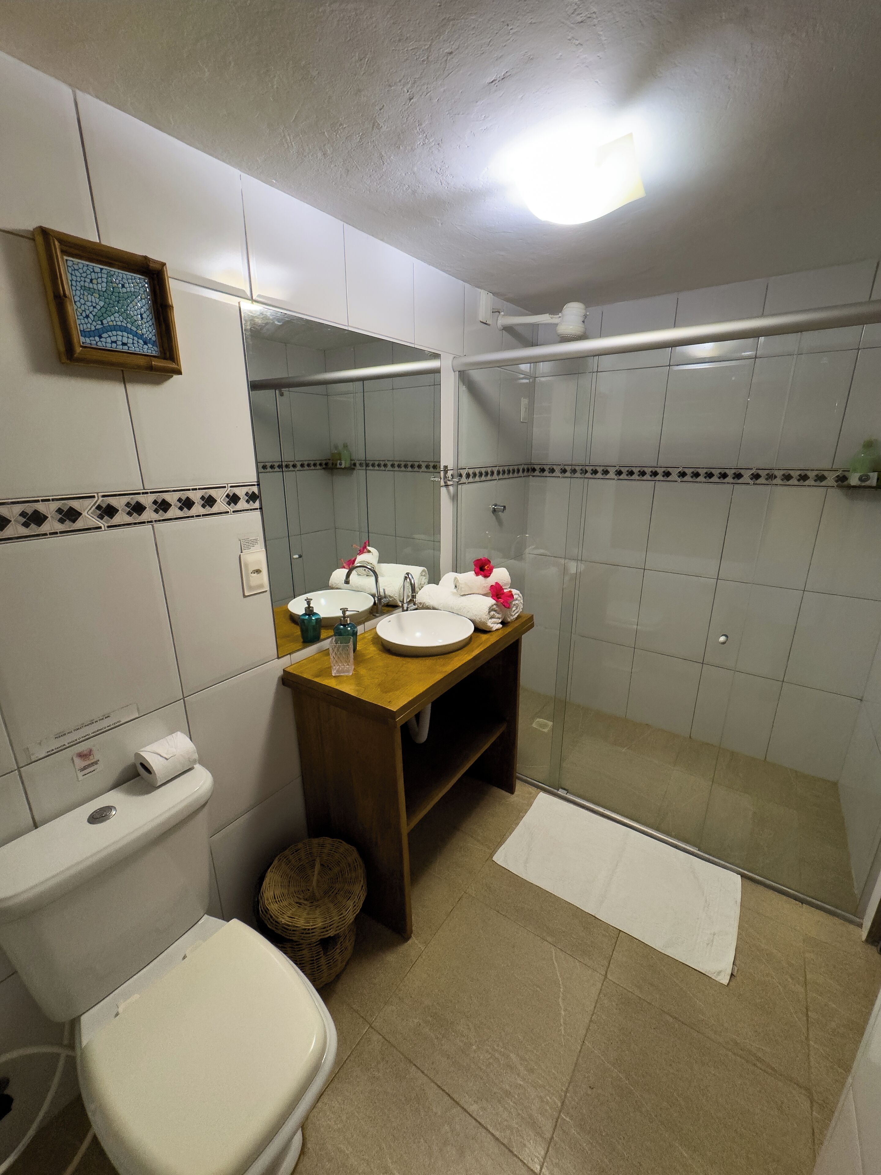 A bathroom with a toilet, sink, and shower.