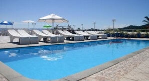 Piscine extérieure, parasols de plage, chaises longues