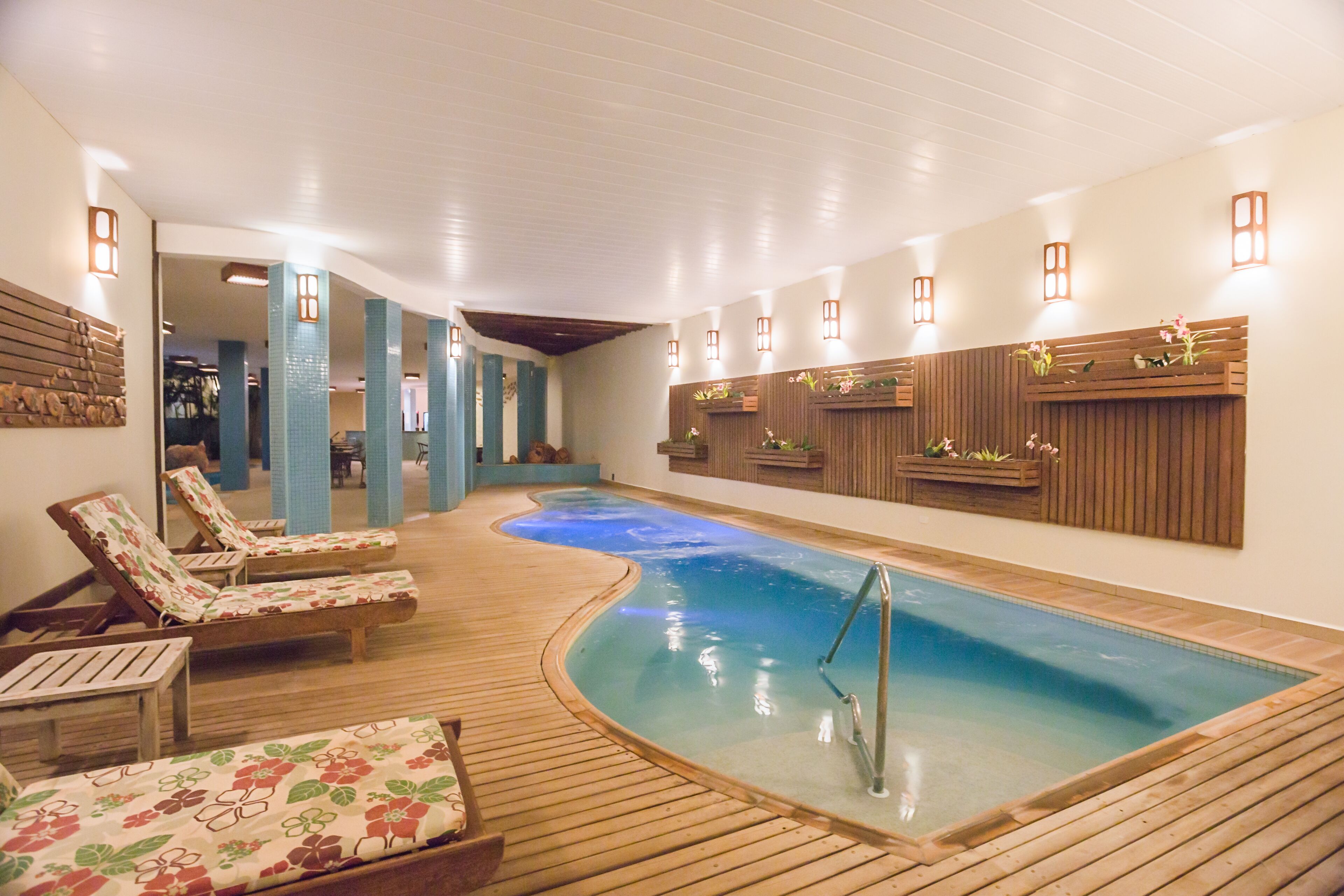 A spa area with a hot tub, wooden loungers, and a wooden deck.