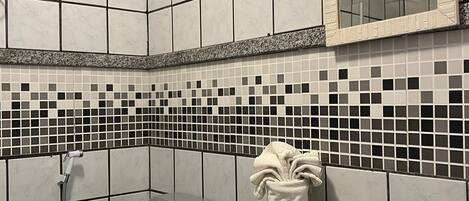 A bathroom with a toilet, sink, and shower.