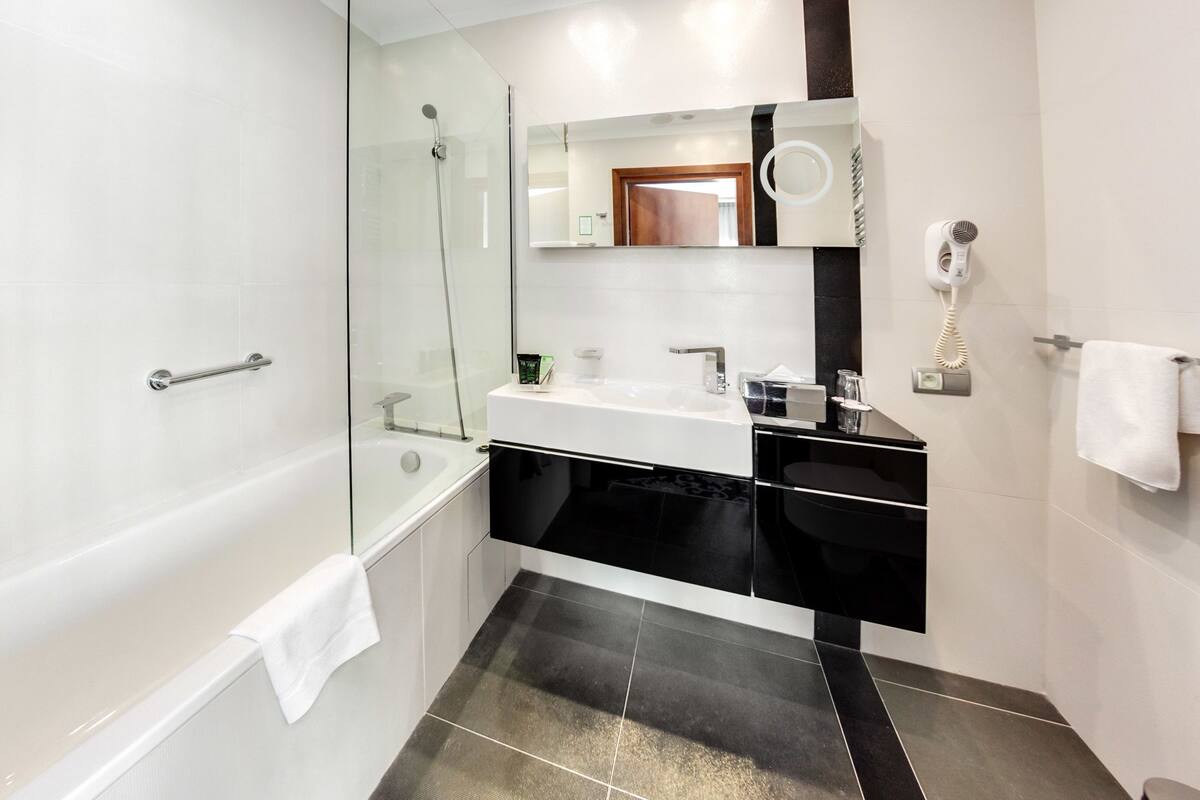 suite, 1 king bed | bathroom | rainfall showerhead, hair dryer, towels, soap