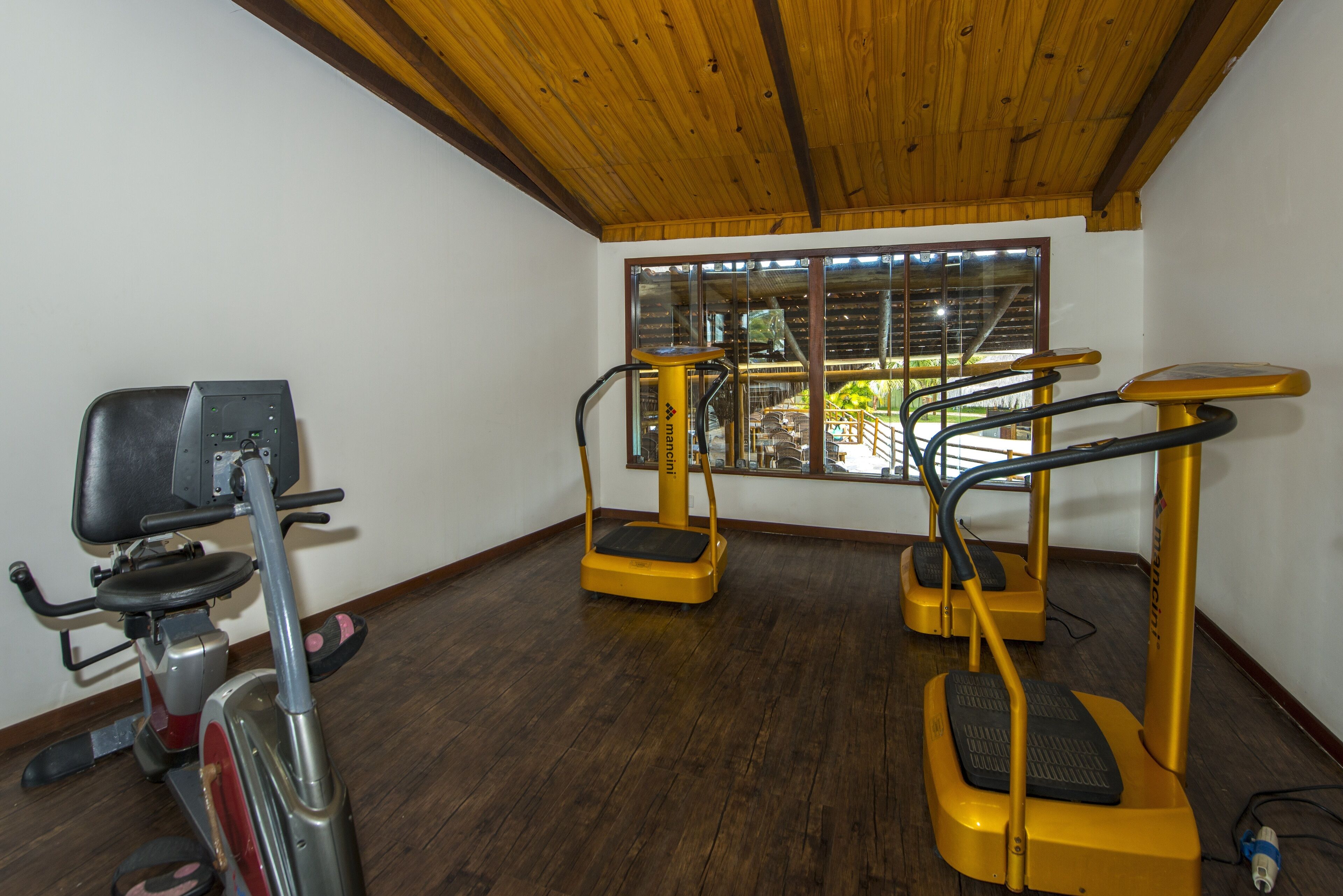 A gym with treadmills and an elliptical machine.