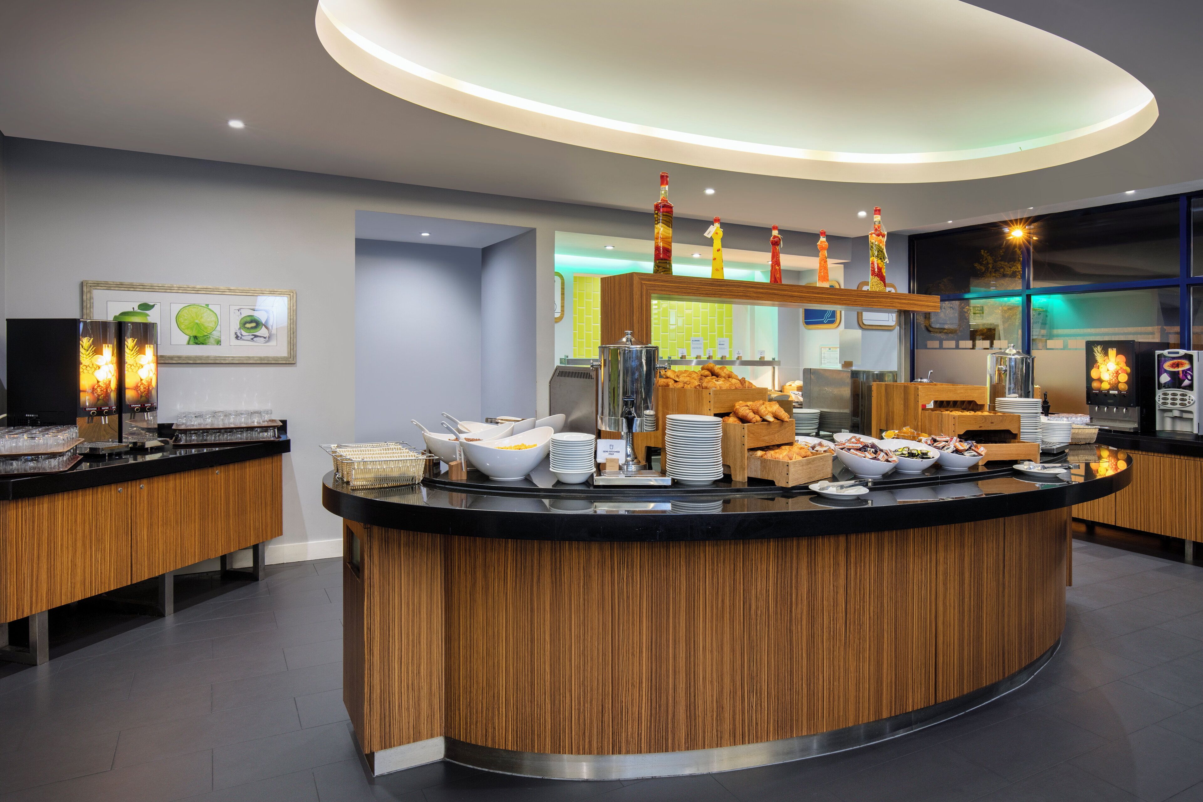 A modern breakfast bar with a variety of food items and a coffee station.