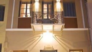 A two-story building with a balcony, large windows, and a central door. - Arxontiko Pepos (Nafpaktos)