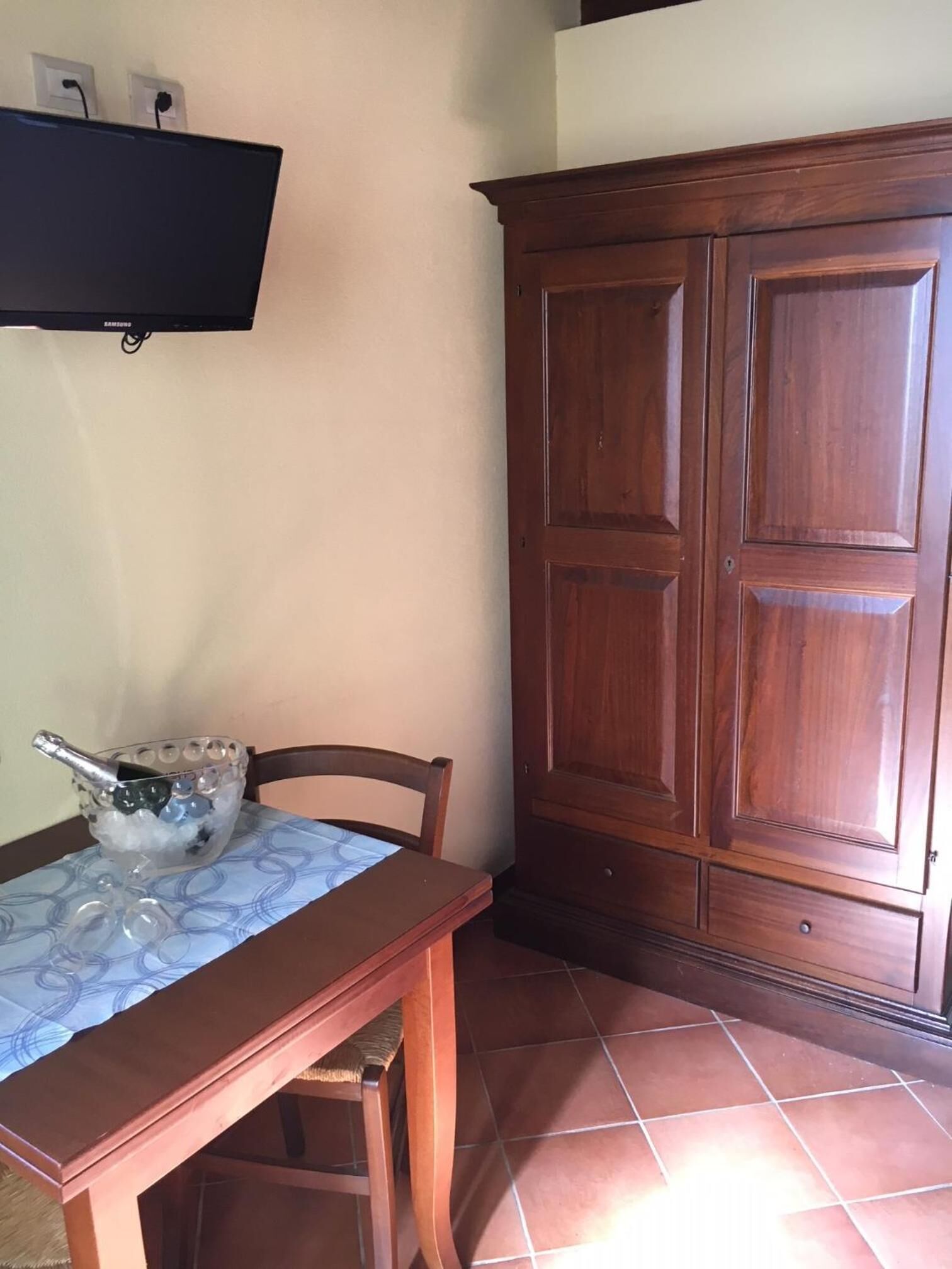 A dining area with a wooden table, chairs, and a cabinet.