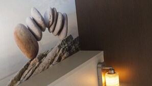 A wall with a textured surface and a light fixture.