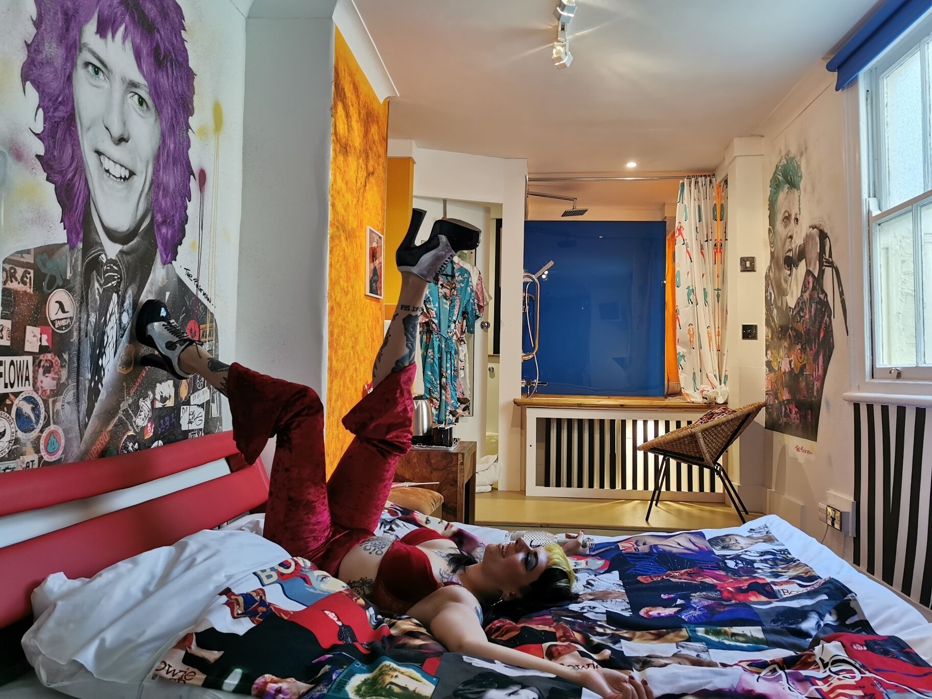 A room with a bed, a chair, and a window.