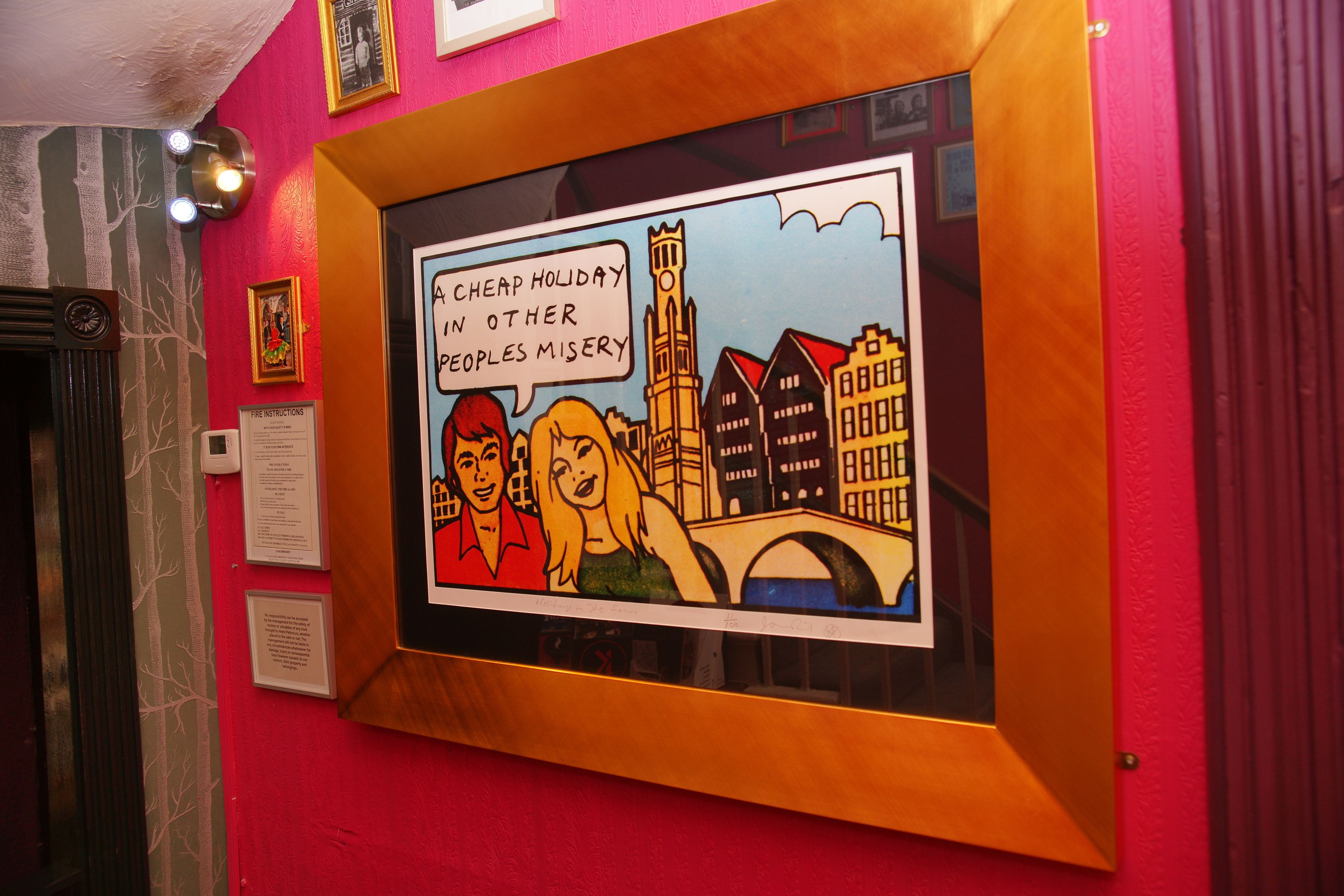 A framed comic-style artwork on a wall with a cityscape background.