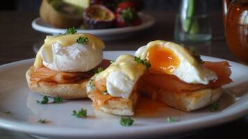 A plate with eggs benedict and smoked salmon.