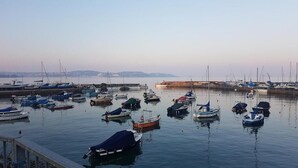 A marina with various boats docked, calm water, and a distant shoreline. - Brampton Guest House (Paignton)