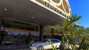 A white car parked in front of a building with "The Orlando" written on the facade. - The Orchard Cebu Hotel & Suites powered by Cocotel (Mandaue)