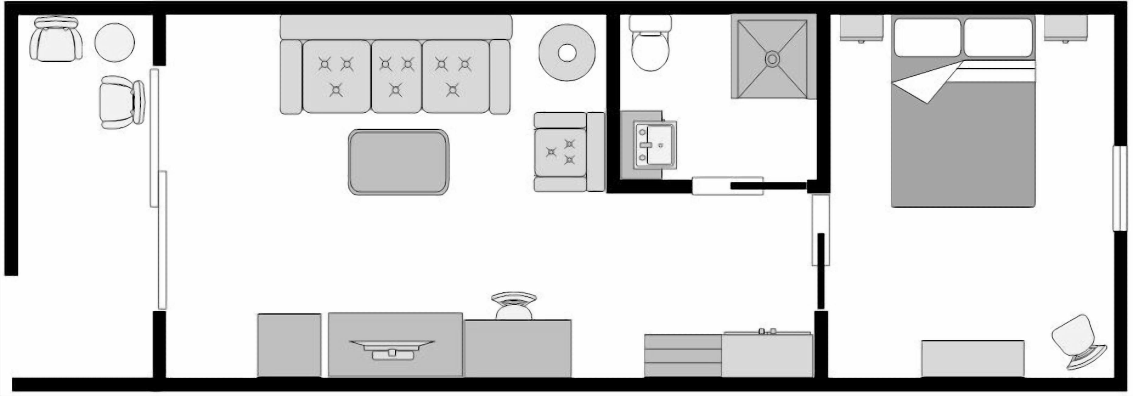 Una cocina con una isla central, un refrigerador, y un lavamanos. Hay armarios y un microondas sobre la encimera.
