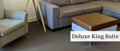 Deluxe King Suite | Living area | 55-inch flat-screen TV with digital channels, TV, DVD player