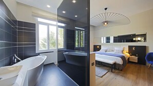 Une salle de bain moderne avec une baignoire sur pieds, une grande fenêtre et un lavabo contemporain.