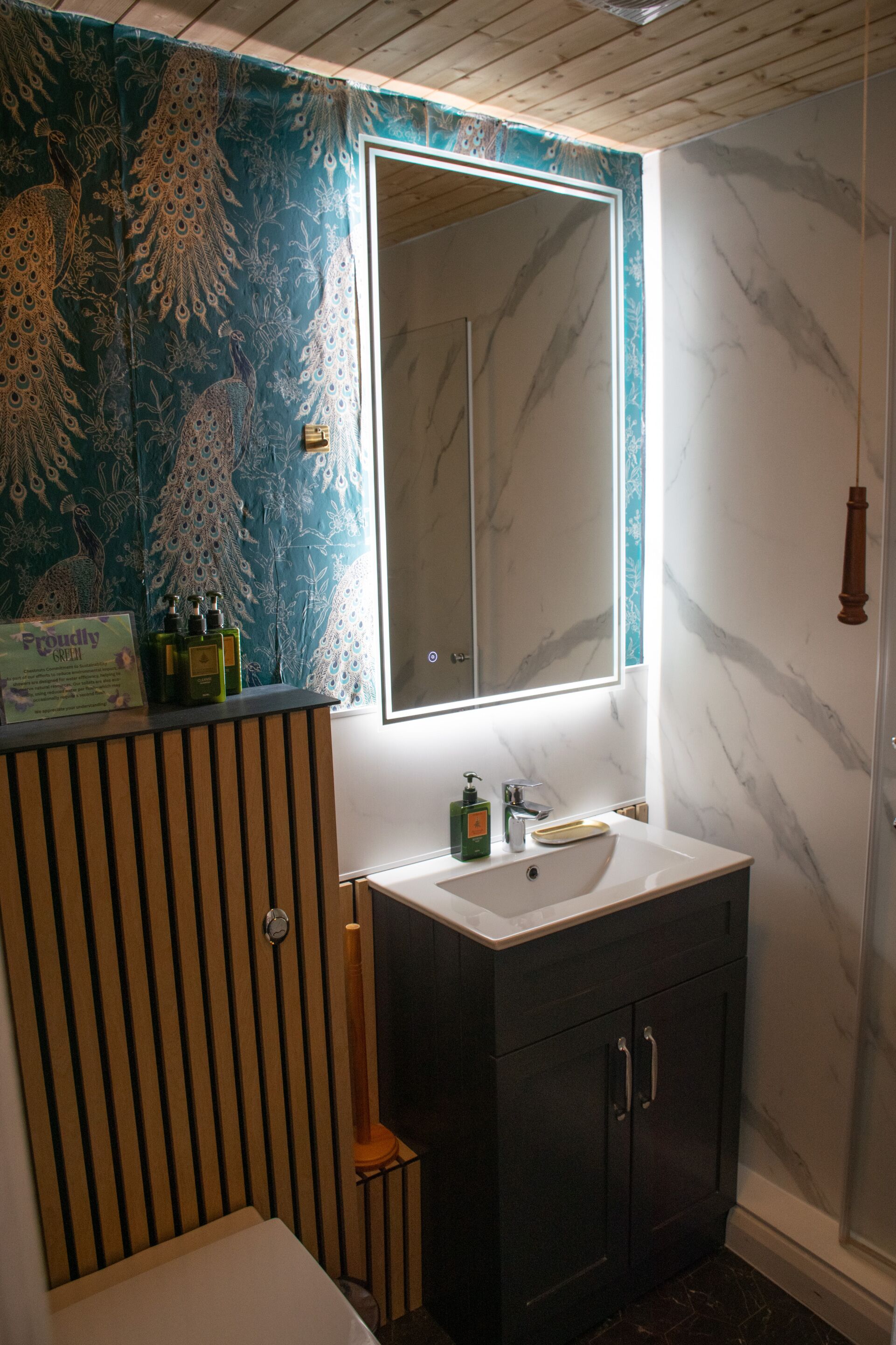 A bathroom with a vanity, sink, and mirror.