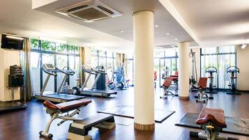 A gym with treadmills, stationary bikes, and weight machines.