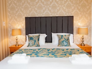A hotel room with a large bed, two nightstands, and a headboard. - The Elmington Hotel (Torquay)