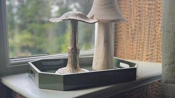 A window sill with a decorative lamp and a small table.