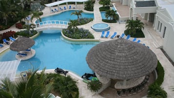 Una piscina al aire libre, sombrillas, tumbonas