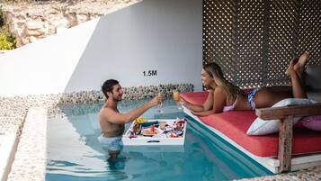 Relax by the serene pool, surrounded by a tranquil landscape.