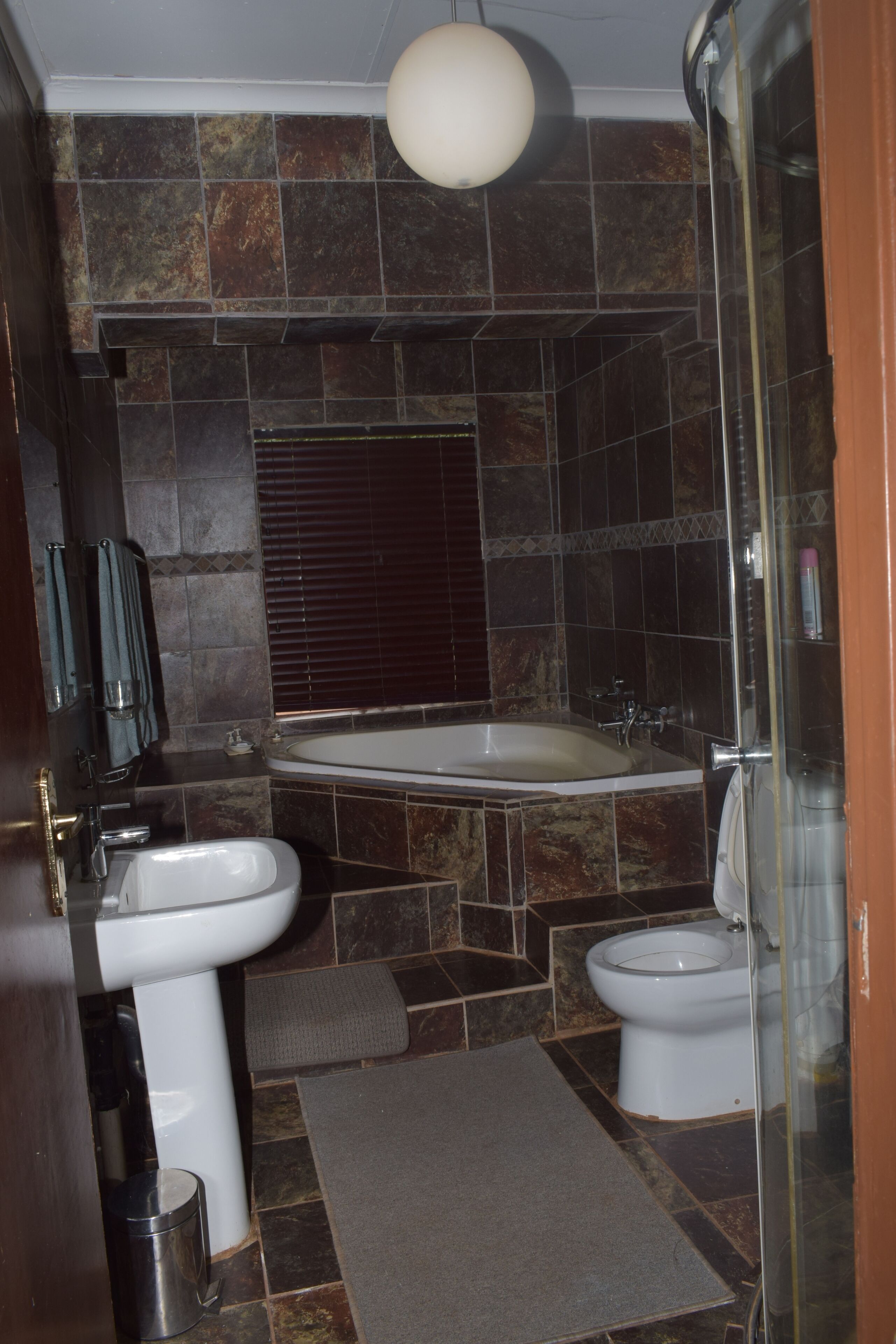 A bathroom with a bathtub, a sink, and a toilet.