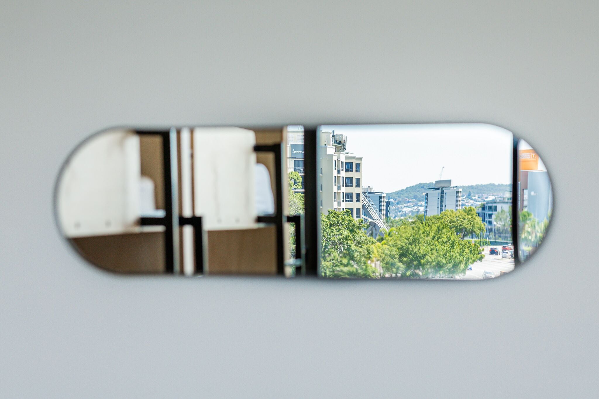 A view through a window with a reflection of a building and trees.
