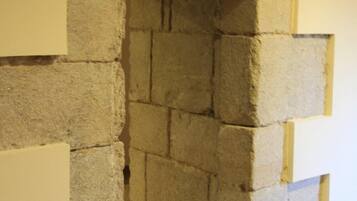 A stone wall structure with a narrow passageway.