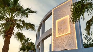A palm tree and a sign with the text "PALM YARD".