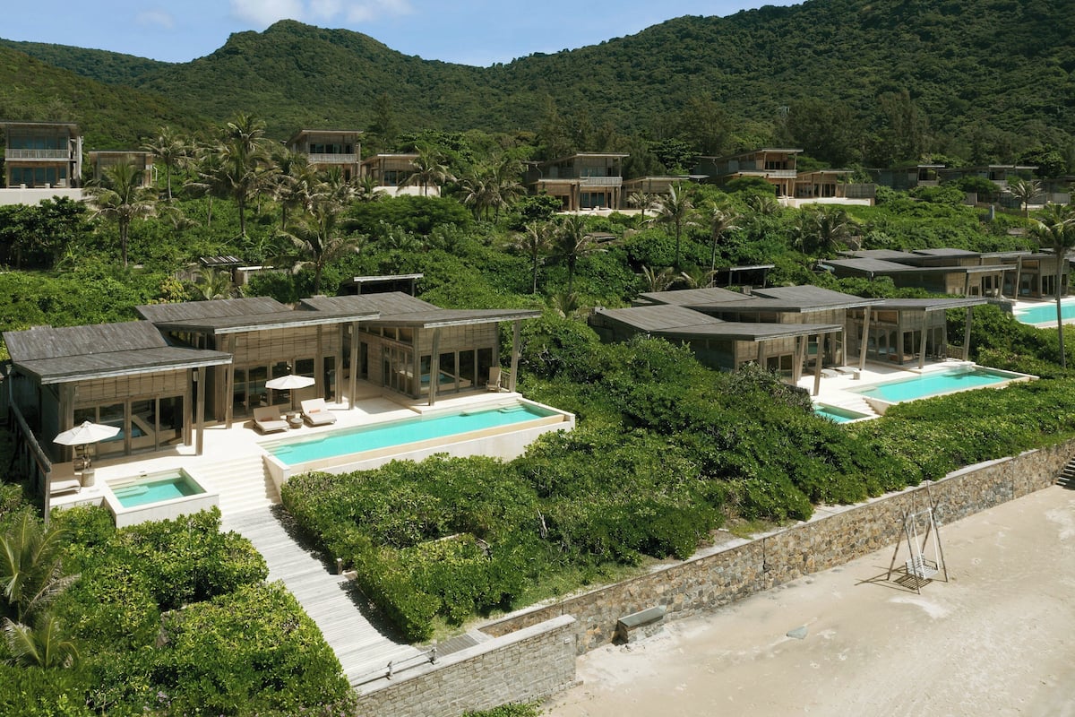 A resort with multiple villas, each with a private pool and surrounded by lush greenery.