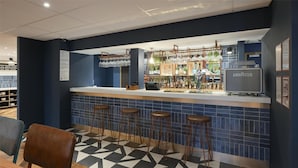 A bar area with stools, a counter, and a coffee machine. - Travelodge Edinburgh Cameron Toll (Edinburgh)