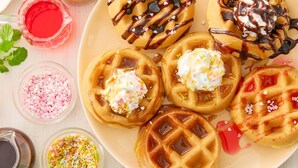 A plate of waffles with various toppings and syrups. - Comfort Inn Kumamoto Miyukifueda (Kumamoto)