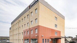 A multi-story hotel with a flat roof and a sign reading "Comfort Inn". - Comfort Inn Hitachinaka (Hitachinaka)