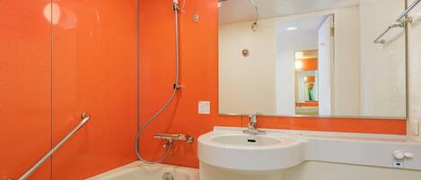 A bathroom with a bathtub, a sink, and a toilet.