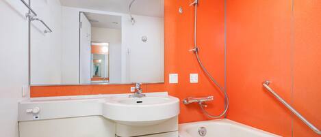 A bathroom with a white sink, mirror, and bathtub.
