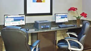 A reception desk with two computer monitors, a printer, and two office chairs. - Holiday Inn Express Hotel & Suites Alvarado by IHG (Alvarado)