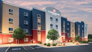 A multi-story hotel with a modern design, featuring a prominent logo and signage. - Candlewood Suites Grand Junction by IHG (Grand Junction)